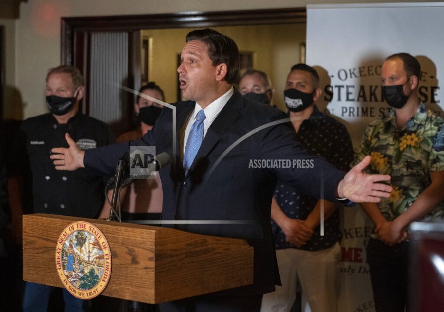 Florida Gov. Ron DeSantis speaks during a news conference at the Okeechobee Steakhouse on Tuesday, Dec. 15, 2020 in West Palm Beach, Fla. DeSantis talked about the importance of keeping restaurants open during the pandemic to help employees earn a living. (Greg Lovett/The Palm Beach Post via AP)