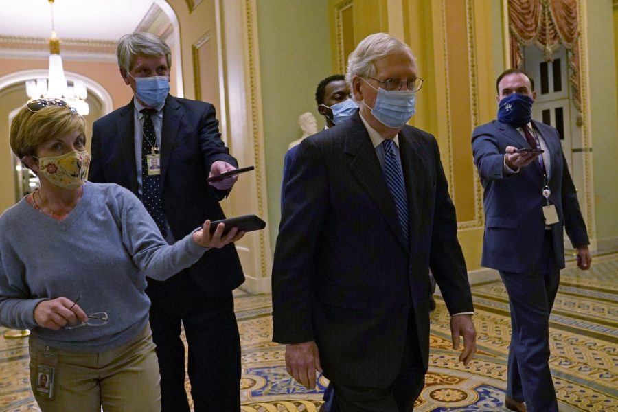 Senate Majority Leader Mitch McConnell of Ky., walks past reporters on Capitol Hill in Washington, Tuesday, Dec. 15, 2020. (AP Photo/Susan Walsh)