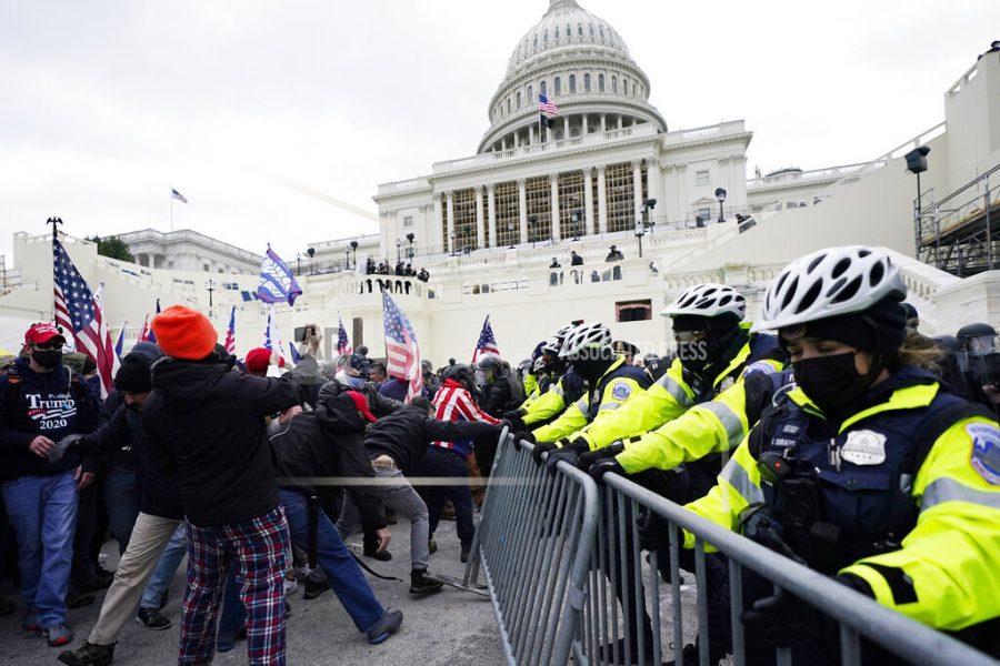Trump supporters try to break through a police barrier, Wednesday, Jan. 6, 2021, at the Capitol in Washington. As Congress prepares to affirm President-elect Joe Bidens victory, thousands of people have gathered to show their support for President Donald Trump and his claims of election fraud. (AP Photo/John Minchillo)