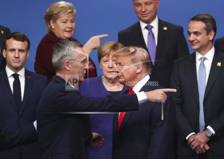 FILE - In this Dec. 4, 2019, file photo, NATO Secretary General Jens Stoltenberg, center front left, speaks with U.S. President Donald Trump, center front right, after a group photo at a NATO leaders meeting at The Grove hotel and resort in Watford, Hertfordshire, England. For America’s allies and rivals alike, the chaos unfolding during Donald Trump’s final days as president is the logical result of four years of global instability brought on by the man who promised to change the way the world viewed the United States. (AP Photo/Francisco Seco, File)