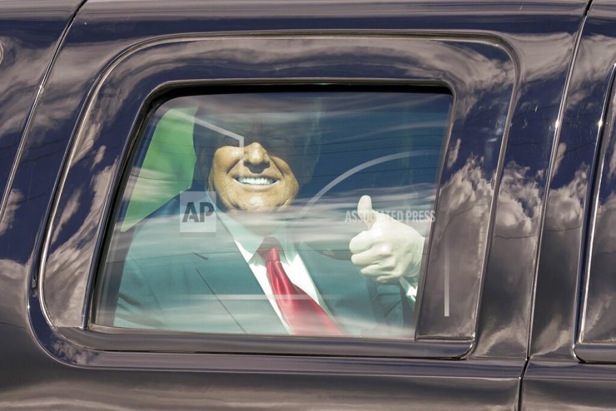 President Donald Trump gestures to supporters en route to his Mar-a-Lago Florida Resort on Wednesday, Jan. 20, 2021, in West Palm Beach, Fla. (AP Photo/Lynne Sladky)