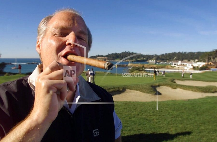 FILE - In this Feb. 3, 2001, file photo, Rush Limbaugh puffs on his Ashton VSG cigar while waiting to tee off from the fifth tee of the Pebble Beach Golf Links during third round play of the AT&T Pebble Beach National Pro-Am in Pebble Beach, Calif. Limbaugh, the talk radio host who became the voice of American conservatism, has died. His death Wednesday, Feb. 17, 2021, at the age of 70 was announced on his website. (AP Photo/Eric Risberg, File)