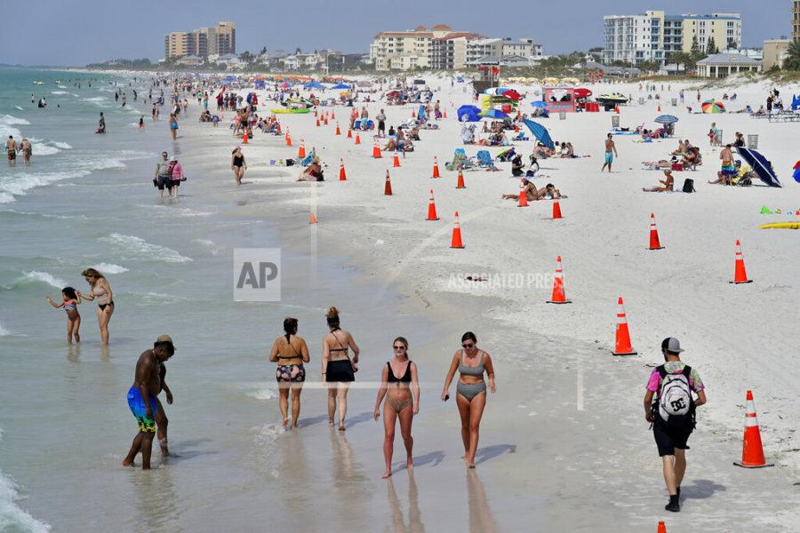 Beachgoers take advantage of the weather as they spend time on Clearwater Beach Tuesday, March 2, 2021, in Clearwater, Fla., a popular spring break destination, west of Tampa. Colleges around the U.S. are scaling back spring break or canceling it entirely to discourage beachfront partying that could raise infection rates back on campus. (AP Photo/Chris OMeara)