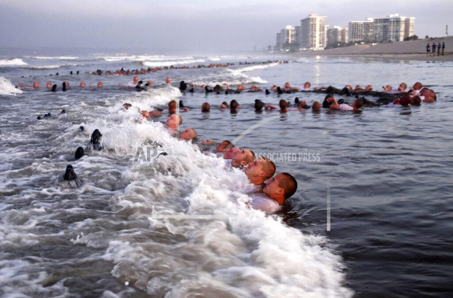FILE - This May 4, 2020, photo provided by the U.S. Navy shows SEAL candidates participating in surf immersion during Basic Underwater Demolition/SEAL (BUD/S) training at the Naval Special Warfare (NSW) Center in Coronado, Calif. U.S. Navy SEALs are undergoing a major transition to improve leadership and expand their commando capabilities. (MC1 Anthony Walker/U.S. Navy via AP)