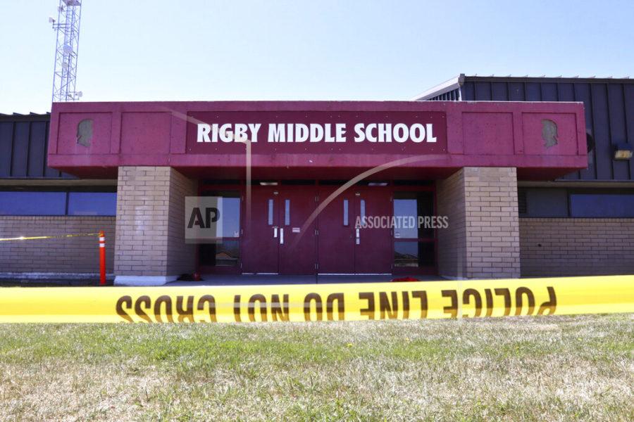 Police tape marks a line outside Rigby Middle School following a shooting there earlier Thursday, May 6, 2021, in Rigby, Idaho. Authorities said that two students and a custodian were injured, and a female student has been taken into custody. (AP Photo/Natalie Behring)