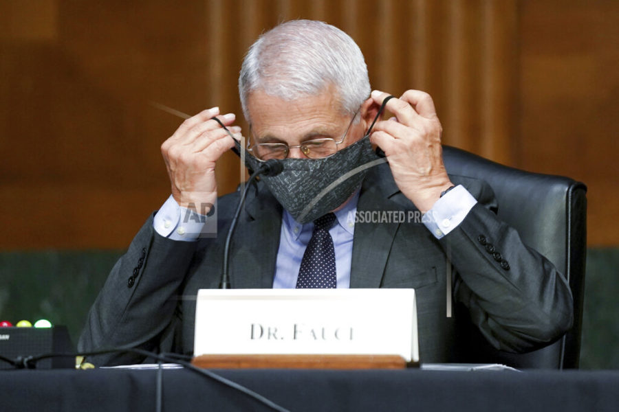 Dr. Anthony Fauci, director of the National Institute of Allergy and Infectious Diseases, puts his face mask back on during a Senate Health, Education, Labor, and Pensions hearing to examine an update from Federal officials on efforts to combat COVID-19, Tuesday, May 11, 2021 on Capitol Hill in Washington. (Jim Lo Scalzo/Pool via AP)