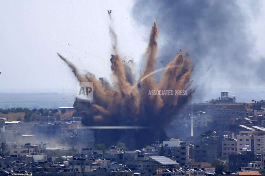 Smoke rises following Israeli airstrikes on a building in Gaza City, Thursday, May 13, 2021. Weary Palestinians are somberly marking the end of the Muslim holy month of Ramadan, as Hamas and Israel traded more rockets and airstrikes and Jewish-Arab violence raged across Israel. (AP Photo/Hatem Moussa)