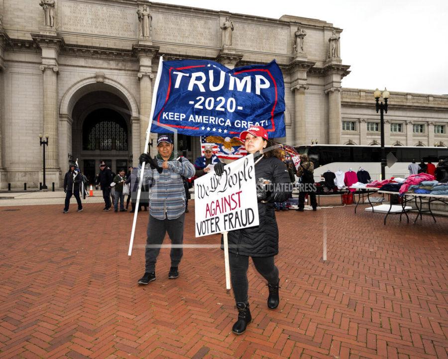 January 6, 2021 - Washington, DC, United States: People carrying a Trump 2020 flag and a sign saying We the people against voter fraud leaving Union Station to go to the Trump Rally in Washington, DC (Photo by Michael Brochstein/Sipa USA)(Sipa via AP Images)
