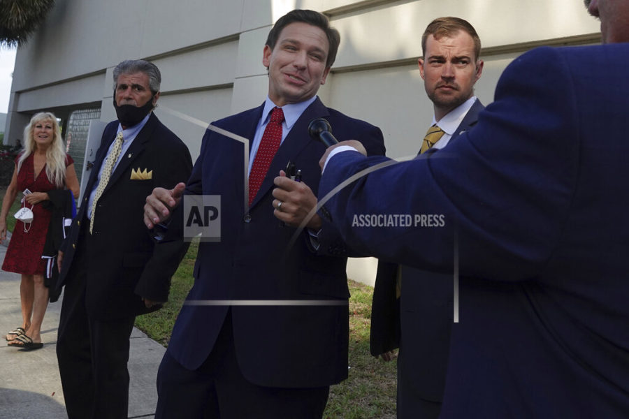 Florida Gov. Ron DeSantis leaves the site of an appearance, Thursday, May 6, 2021, in West Palm Beach, Fla.  DeSantis has signed a sweeping elections bill into law that he and other Republicans said would place guardrails against fraud, even though there were no signs of voter irregularities in the November presidential election.  (Joe Cavaretta/South Florida Sun-Sentinel via AP)
