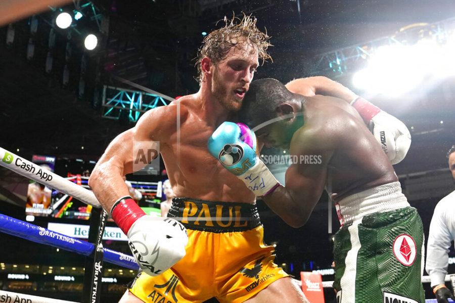 Logan Paul, left and Floyd Mayweather fight during an exhibition boxing match at Hard Rock Stadium, Sunday, June 6, 2021, in Miami Gardens, Fla. (AP Photo/Lynne Sladky)