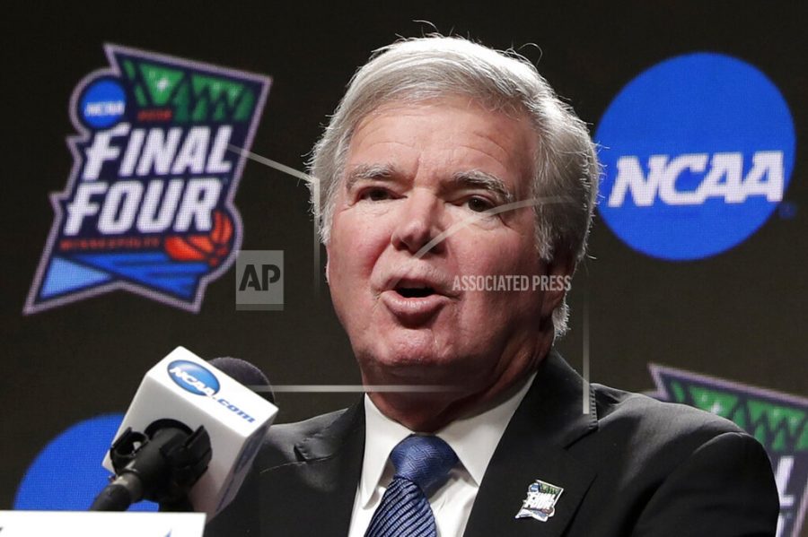 In this April 4, 2019, file photo, NCAA President Mark Emmert answers questions at a news conference at the Final Four college basketball tournament in Minneapolis. Emmert told the organizations more than 1,200 member schools Friday, June 18, 2021, that he will seek temporary rules as early as July to ensure all athletes can be compensated for their celebrity with a host of state laws looming and congressional efforts seemingly stalled.  (AP Photo/Matt York, File)