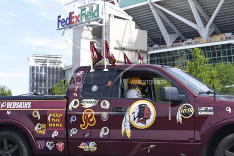 FILE - In this July 13, 2020, file photo, Rodney Johnson of Chesapeake, Va., sits in his truck outside FedEx Field in Landover, Md. Washingtons NFL team will not be called the Warriors or have any other Native American imagery in the new name when its revealed next year. (AP Photo/Susan Walsh, File)