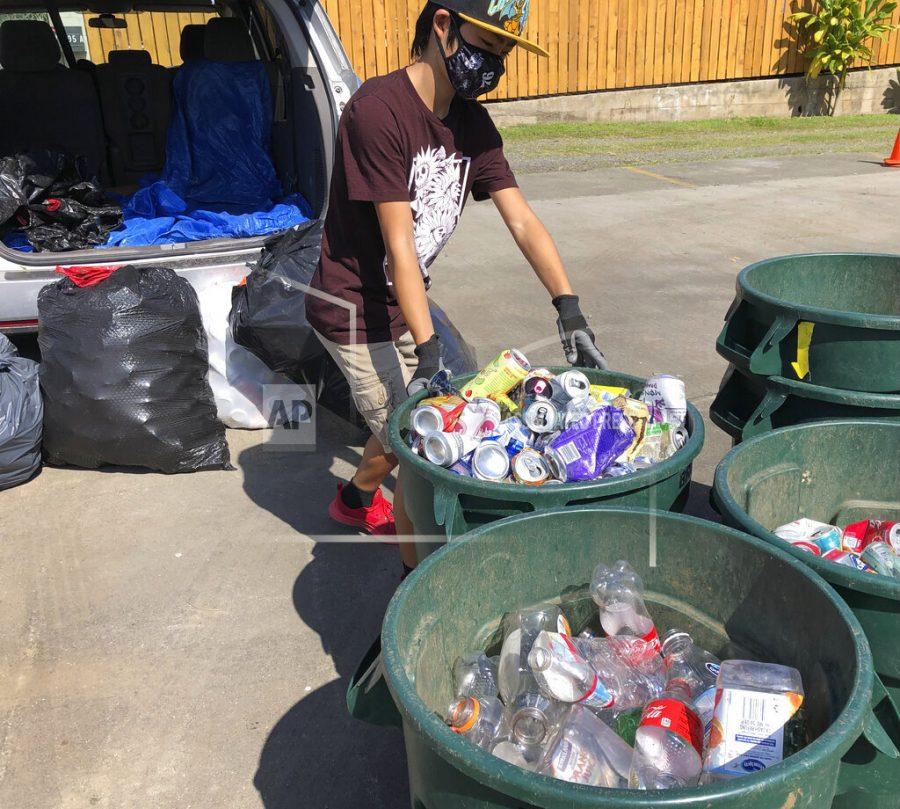 In this June 2021 photo provided by Maria Price,  Genshu Price drops off cans and bottles at a recycling center in Kahaluʻu, Hawaii. Price has recycled over 100,000 cans and bottles to raise money for students college tuition through his fundraiser, Bottles4College. (Bottles4College via AP)