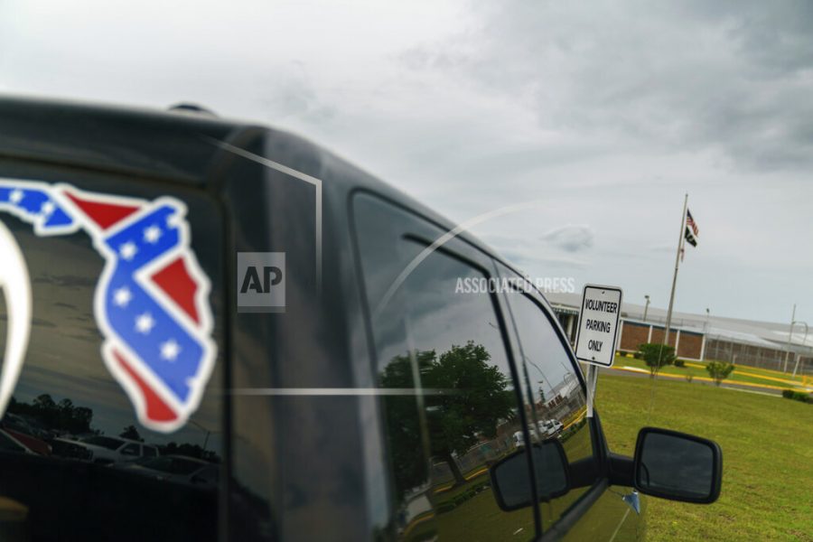 A pickup truck with a Confederate flag-themed decal is parked outside the Reception and Medical Center, the states prison hospital where new inmates are processed, in Lake Butler, Fla., Friday, April 16, 2021. In 2013, at a prison dorm room in the facility, Warren Williams, a Black inmate who suffered from severe anxiety and depression, found himself in front of Thomas Driver, a white prison guard, after he lost his identification badge, a prison infraction. (AP Photo/David Goldman)