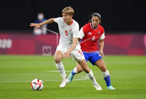 Canadas Quinn, left, and Chiles Karen Araya battle for the ball during a womens soccer match at the 2020 Summer Olympics, Saturday, July 24, 2021, in Sapporo, Japan. (AP Photo/Silvia Izquierdo)