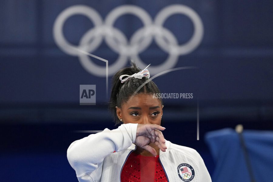 Simone Biles, of the United States, watches gymnasts perform at the 2020 Summer Olympics, Tuesday, July 27, 2021, in Tokyo. Biles says she wasnt in right headspace to compete and withdrew from gymnastics team final to protect herself. (AP Photo/Ashley Landis)