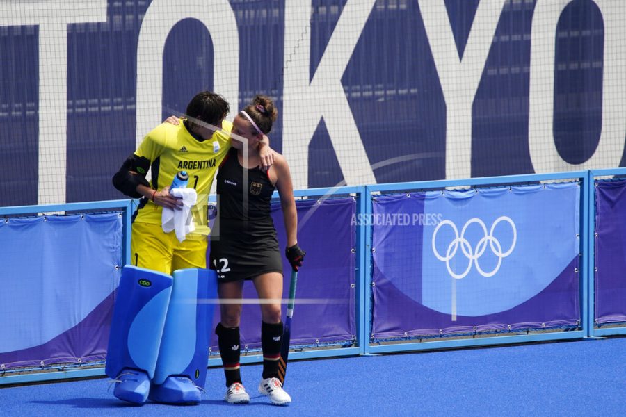 FILE - In this Aug. 2, 2021, file photo, Argentina goalkeeper Maria Belen Succi (1) comforts Germanys Charlotte Stapenhorst, right, after Argentina won their womens field hockey match at the 2020 Summer Olympics, in Tokyo, Japan. In an extraordinary Olympic Games where mental health has been front and center, acts of kindness are everywhere. The world’s most competitive athletes have been captured showing gentleness and warmth to one another — celebrating, pep-talking, wiping away each another’s tears of disappointment.  (AP Photo/John Locher, File)