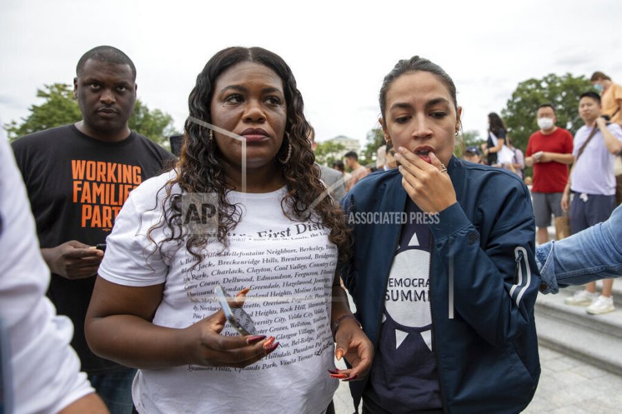 Rep. Cori Bush, D-Mo., and Rep. Alexandria Ocasio-Cortez, D-N.Y., react to the announcement that the Biden administration will enact a targeted nationwide eviction moratorium outside of Capitol Hill in Washington on Tuesday, Aug. 3, 2021. (AP Photo/Amanda Andrade-Rhoades)