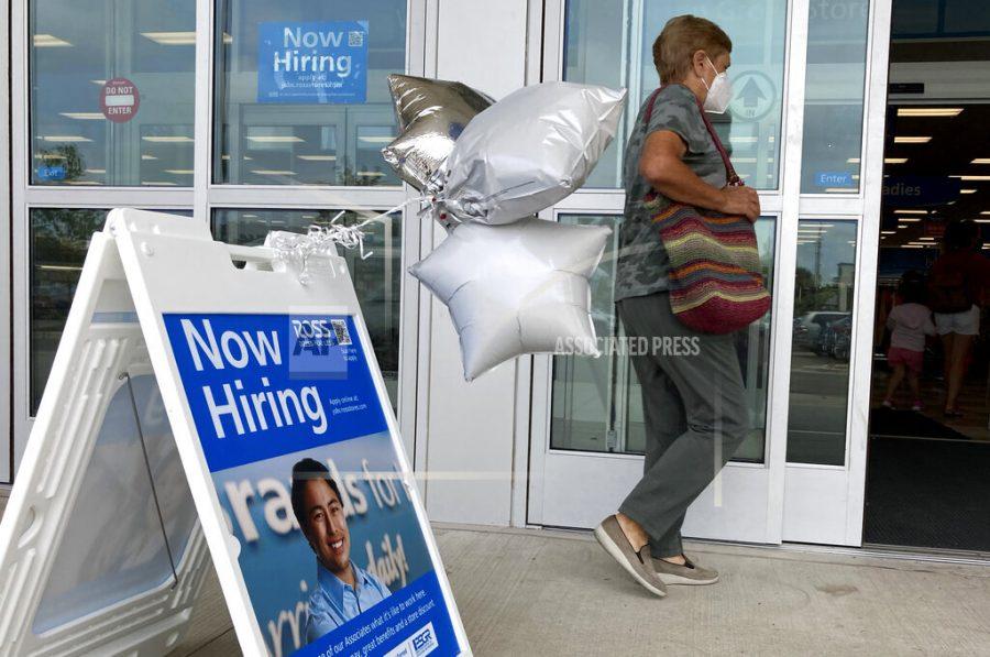 A shopper passes a hiring sign while entering a retail store in Morton Grove, Ill., Wednesday, July 21, 2021. Despite an uptick in COVID-19 cases and a shortage of available workers, the U.S. economy likely enjoyed a burst of job growth last month as it bounces back with surprising vigor from last year’s coronavirus shutdown. The Labor Department’s July jobs report Friday, Aug. 6 is expected to show that the United States added more than 860,000 jobs in July, topping June’s 850,000, according to a survey of economists by the data firm FactSet.   (AP Photo/Nam Y. Huh)