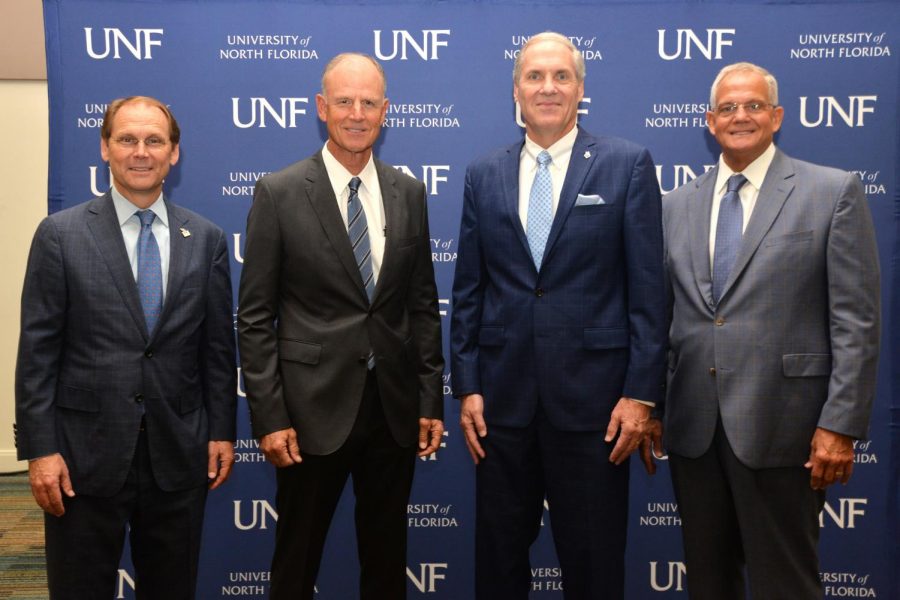 In this 2021 photo, David Szymanski (second from right) stands beside Kevin Hyde, UNF Board of Trustees chair (far left); Sydney Kitson, then-Florida State University System Board of Governors chair (second from left); Marshall M. Criser, then-Florida State University System chancellor (far right). (Photo courtesy of UNF)