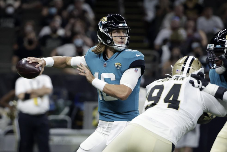 Jacksonville Jaguars quarterback Trevor Lawrence (16) drops back to pass under pressure from New Orleans Saints defensive end Cameron Jordan (94) in the first half of an NFL preseason football game in New Orleans, Monday, Aug. 23, 2021. (AP Photo/Derick Hingle)