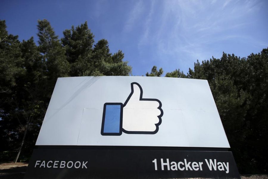 In this April 14, 2020 file photo, the thumbs up Like logo is shown on a sign at Facebook headquarters in Menlo Park, Calif. Facebook says it plans to hire 10,000 workers in the European Union over the next five years to work on a new computing platform. The company said in a blog post Sunday, Oct. 17, 2021 that those high-skilled workers will help build “the metaverse,” a futuristic notion for connecting people online that uses augmented and virtual reality. (AP Photo/Jeff Chiu, File).