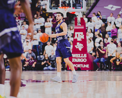 UNF guard Jose Placer dribbles the ball up the court on Wednesday against Texas A&M (Photo by Jeremiah Wilson).