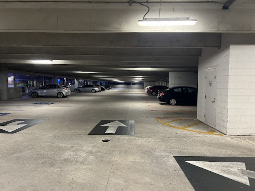 Parked cars sit on the bottom floor of the Fine Arts Center Parking Garage (Building 44). 