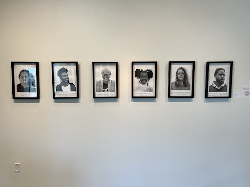 A display of black and white portraits by Melody Verkerk. 