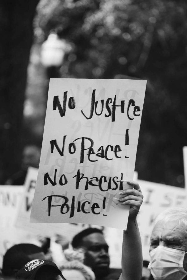 A sign is held up during a BLM protest in downtown Jacksonville.