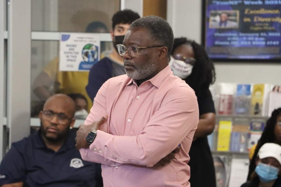 Rudy F. Jamison listens to a student.