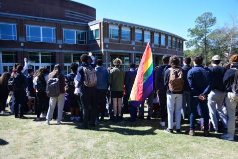 An unidentified person holds an LGBT Pride flag alongside a flock of students as they listen to Sister Cindy preach on the University of North Florida Green Valentine’s Day afternoon in Jacksonville, Florida, Monday, Feb. 14.