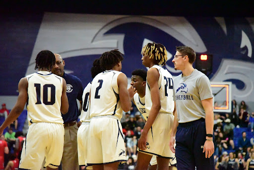 While unable to play, UNF forward Carter Hendricksen (right) coaches up his teammates during a timeout at UNF Arena in Jacksonville, Florida, Tuesday, Feb. 15.