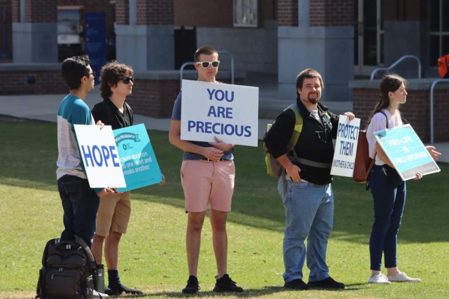 Members of UNF’s Pro-Life Club hold signs supporting anti-abortion legislation on the University of North Florida Green in Jacksonville, Florida, Wednesday, Feb. 16.