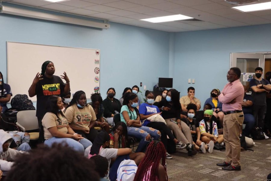Rudy F. Jamison listens to a student talk about her experiences at the Intercultural Center.