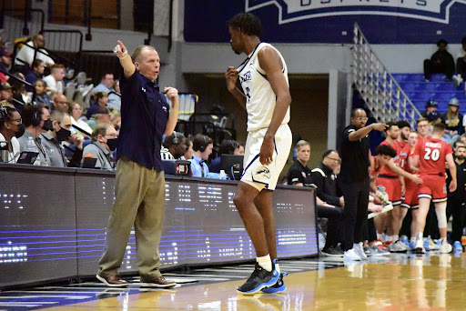 University of North Florida Basketball Head Coach Matthew Driscoll instructs guard Jordan Preaster during a stoppage in play at UNF Arena in Jacksonville, Florida, Tuesday, Feb. 15.