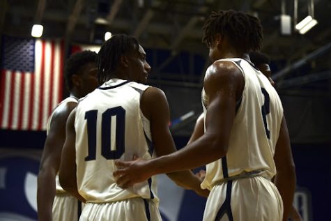UNF teammates Jarius Hicklen (10) and Chaz Lanier (2) chat during a stoppage in play.