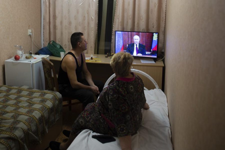 People from the Donetsk and Luhansk regions, the territory controlled by a pro-Russia separatist governments in eastern Ukraine, watch Russian President Vladimir Putins address at their temporary place in Rostov-on-Don region, Russia, Monday, Feb. 21, 2022. Putin said he would decide later Monday whether to recognize the independence of separatist regions in eastern Ukraine, a move that would ratchet up tensions with the West amid fears that Moscow could launch an invasion of Ukraine imminently. (AP Photo/Denis Kaminev)