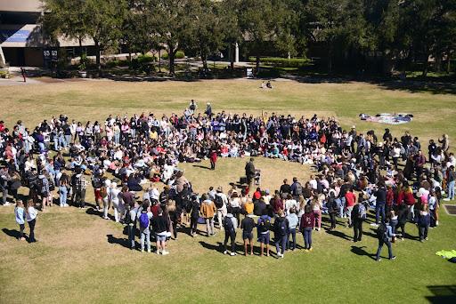 Approximately 100 students circle around Sister Cindy while she preaches on the University of North Florida Green Valentine’s Day afternoon in Jacksonville, Florida, Monday, Feb. 14. 