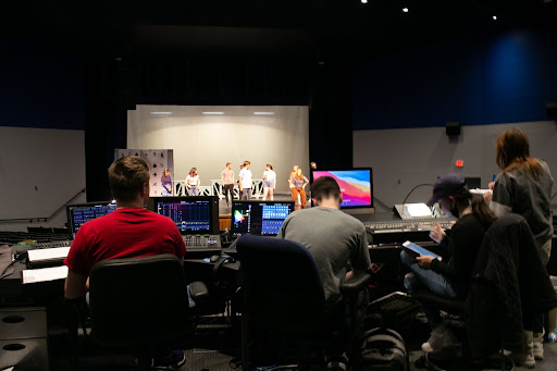 Students work behind the scenes during a rehearsal for the Lightning Thief show.