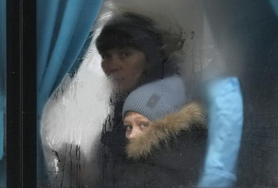 A+woman+and+child+peer+out+of+the+window+of+a+bus+as+they+leave+Sievierodonetsk