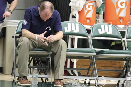 UNF Head Coach Matthew Driscoll sits silently in frustration as his team took a 18-point deficit into halftime.