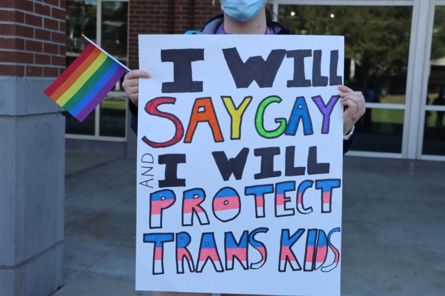 Allison Bradish holds up a sign at a protest speaking out against anti-LGBTQ legislation on March 2, 2022, on the UNF Green.