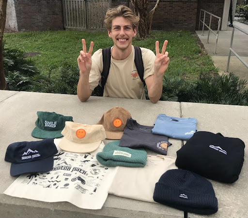 Miles Dittmar smiles with some of his products outside UNF’s Library.