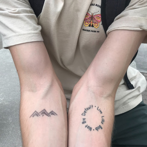 The Beaten Path Co. logo in Sharpie ink on Dittmar’s arm (left).