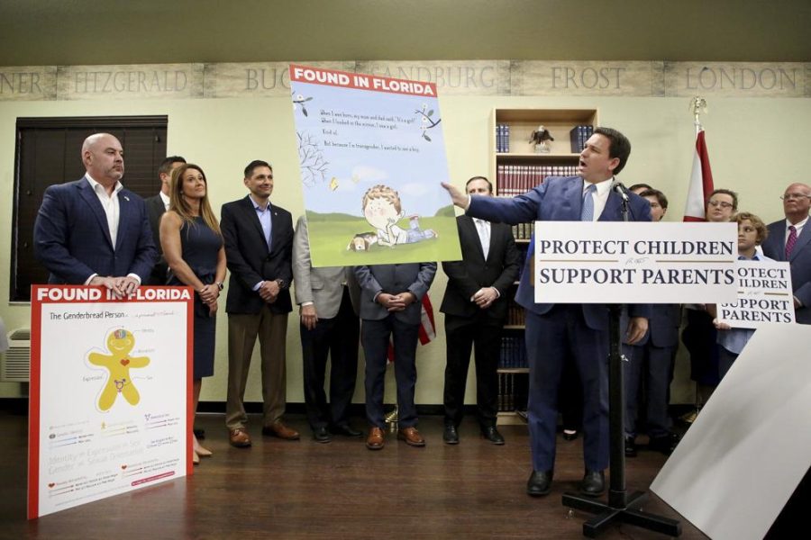 Florida Gov. Ron DeSantis shows an image from the children's book Call Me Max by transgender author Kyle Lukoff moments before signing the Parental Rights in Education bill during a news conference on Monday, March 28, 2022, at Classical Preparatory school in Shady Hills. At left is an image of The Genderbread Person, a teaching tool used for breaking the concept of gender.