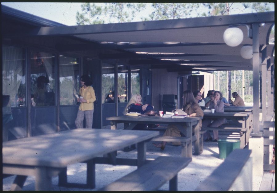 Unidentified people at tables outside the original Boathouse, circa 1973-1975.