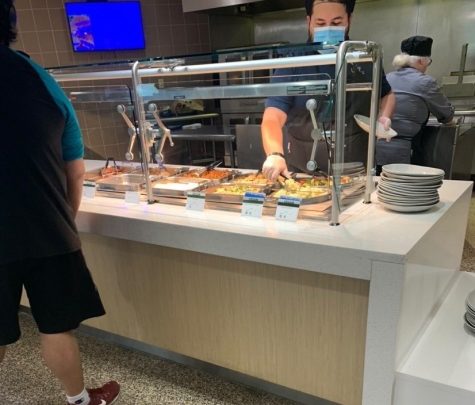 A student waits in line for food in the UNF Cafe.