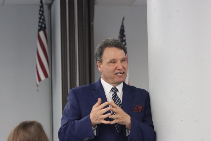 Presidential Candidate Moez Limayem answers a question during his student meet-and-greet pizza session