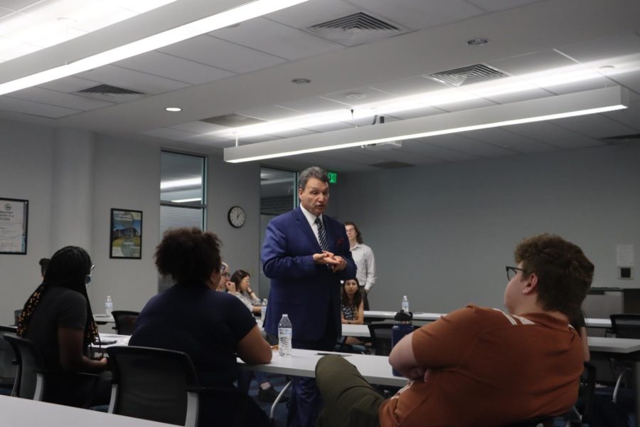 Presidential Candidate Moez Limayem walks around the room as he answers questions during his student meet-and-greet session on May 5, 2022, in the Thomas G. Carpenter Library.